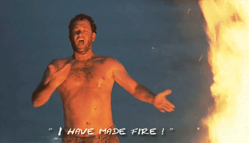 Tom Hanks in Castaway saying 'I have made fire', while gesturing to the bonfire in front of him.