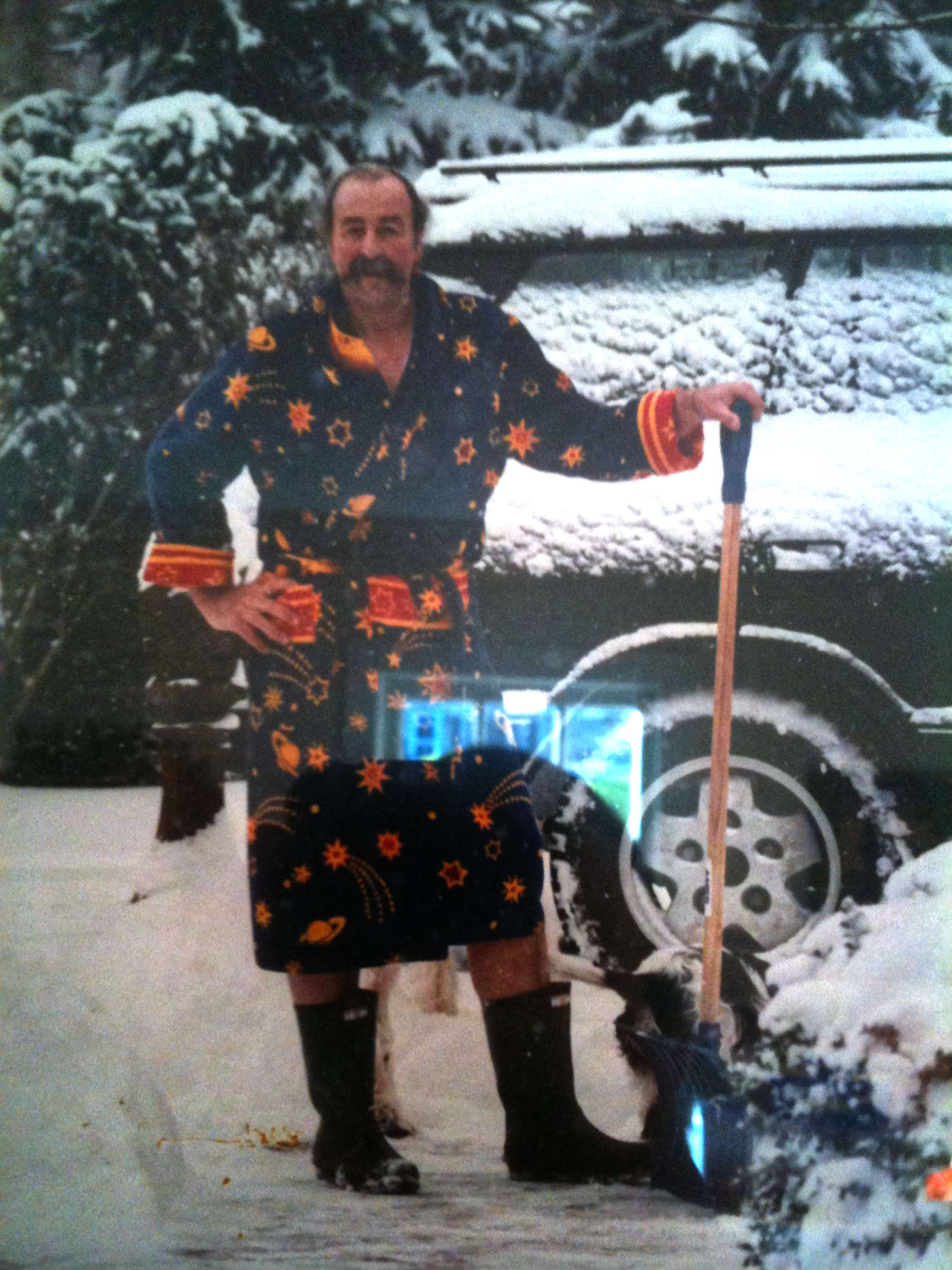 Bruce Nadel in his classic wizard robe shoveling snow in his fireman's boots.